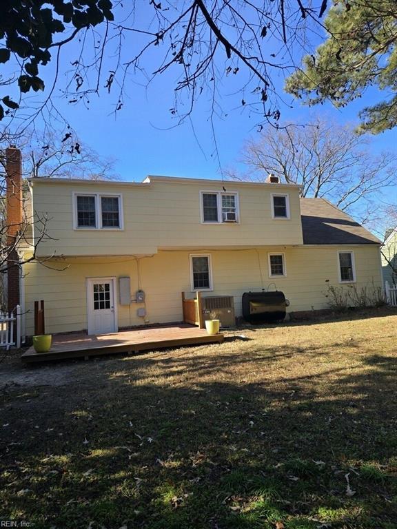 back of house with a lawn and a wooden deck