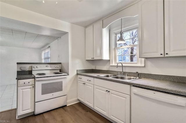 kitchen with white cabinetry, white appliances, and sink