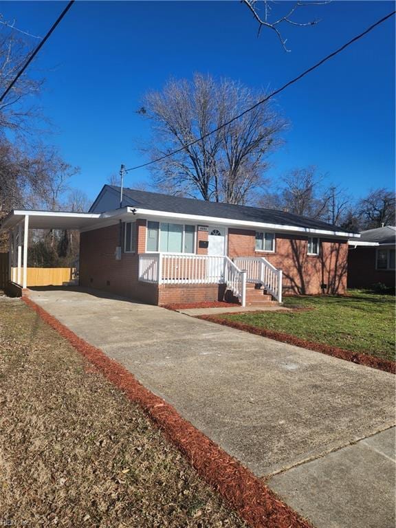 ranch-style house with a front yard and a carport