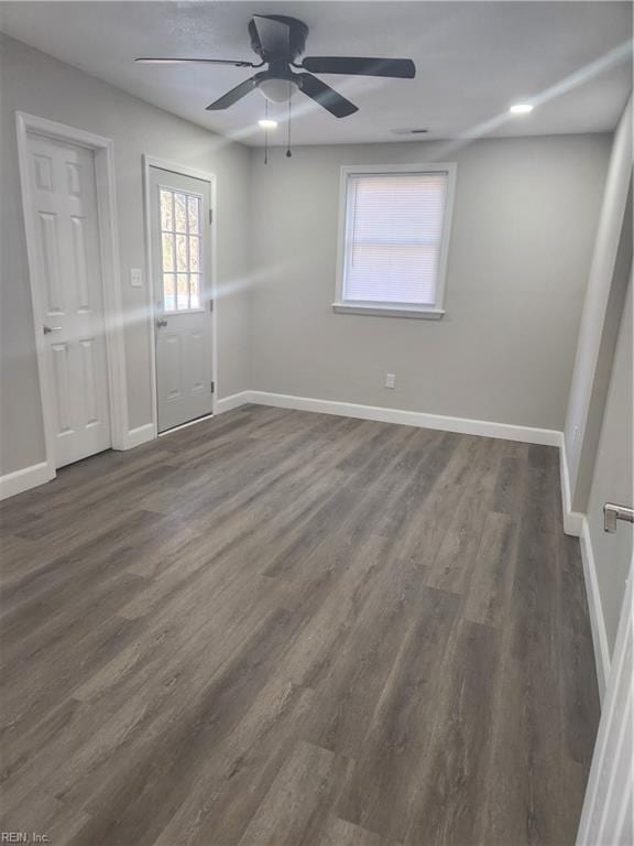 empty room featuring dark hardwood / wood-style flooring and ceiling fan