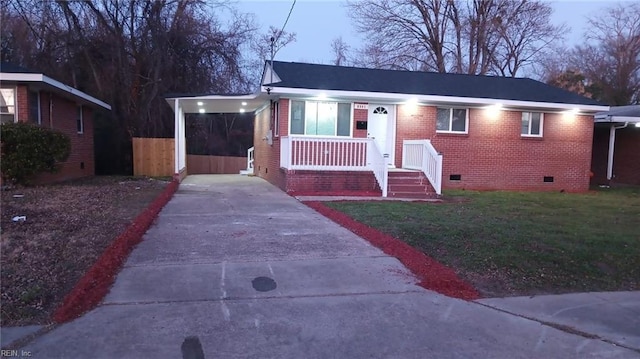 view of front of home with a lawn and a carport