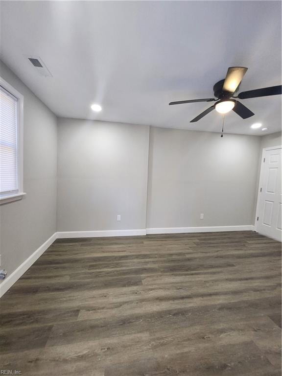 spare room with dark hardwood / wood-style floors and ceiling fan