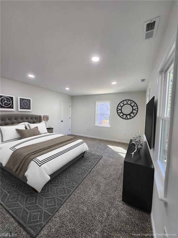 carpeted bedroom with multiple windows