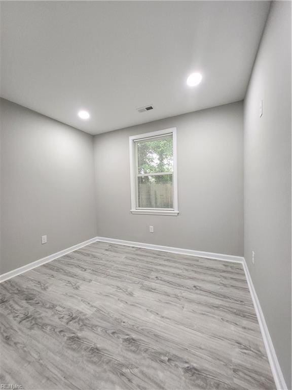 unfurnished room with light hardwood / wood-style floors