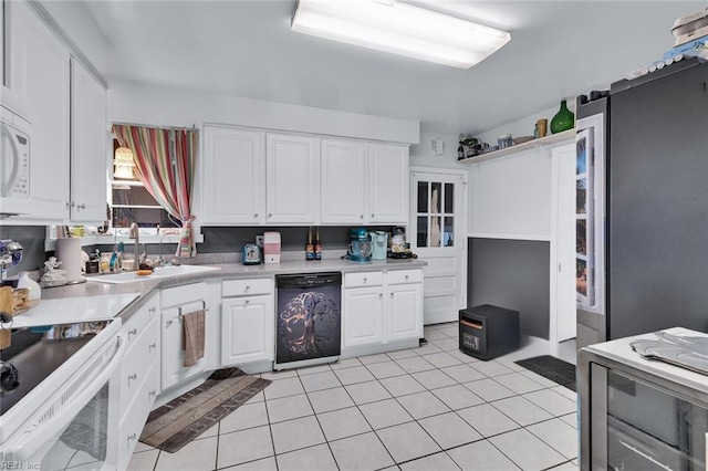 kitchen featuring black dishwasher, light tile patterned floors, white cabinets, white electric range oven, and sink