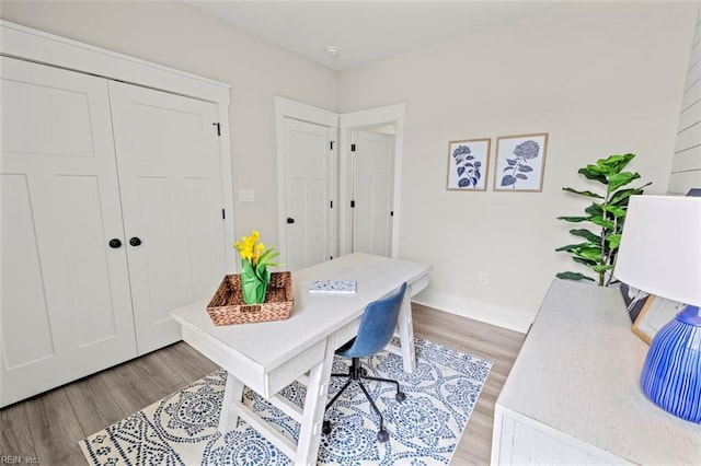 office with light hardwood / wood-style flooring