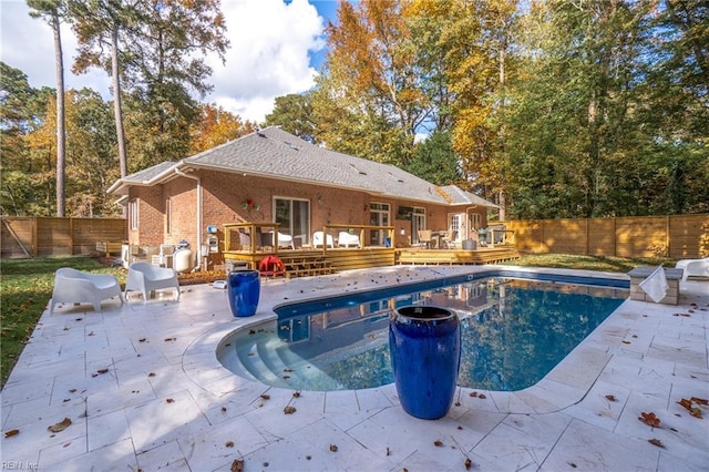 view of swimming pool with a patio and a deck