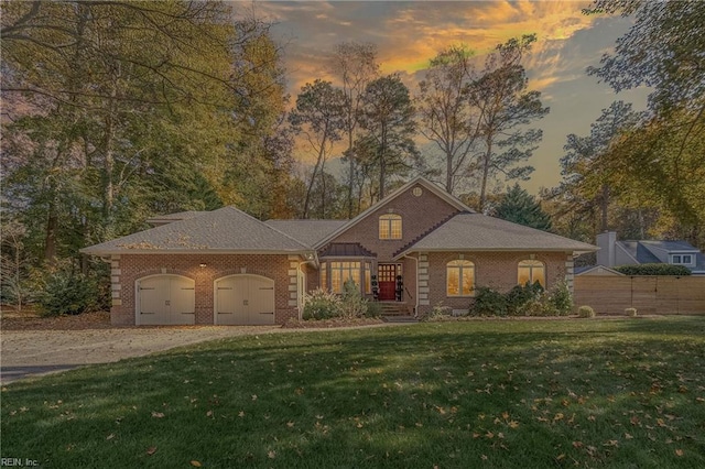 view of front of house with a lawn and a garage