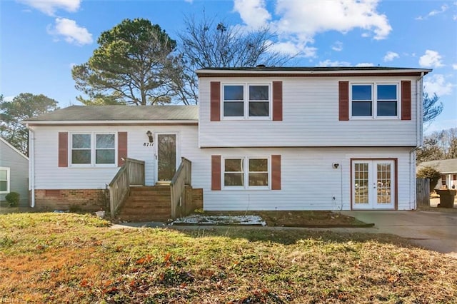 view of front of home featuring a front yard and french doors