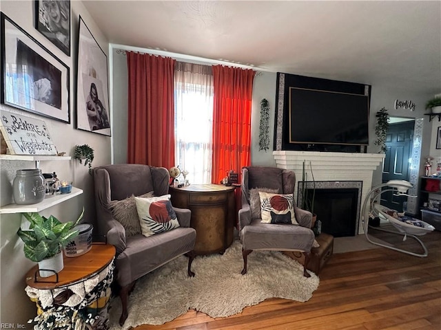 sitting room with wood-type flooring and a fireplace