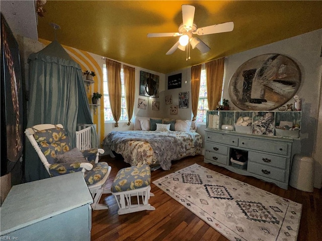 bedroom with ceiling fan and dark hardwood / wood-style floors