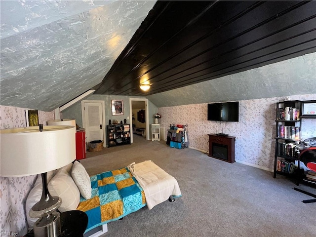 carpeted bedroom featuring lofted ceiling