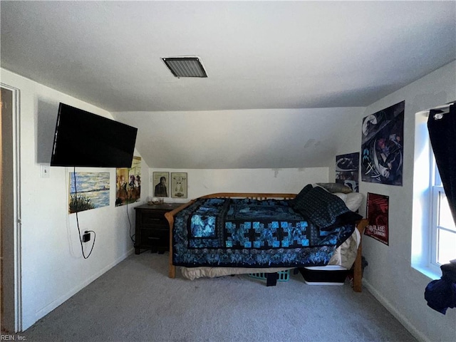 carpeted bedroom with lofted ceiling