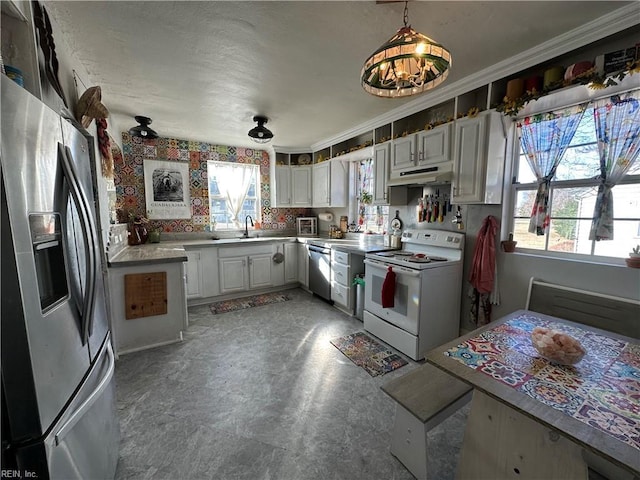 kitchen with white cabinetry, sink, hanging light fixtures, stainless steel appliances, and a notable chandelier