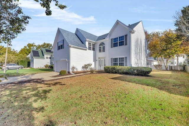 view of front of home featuring a front yard and a garage