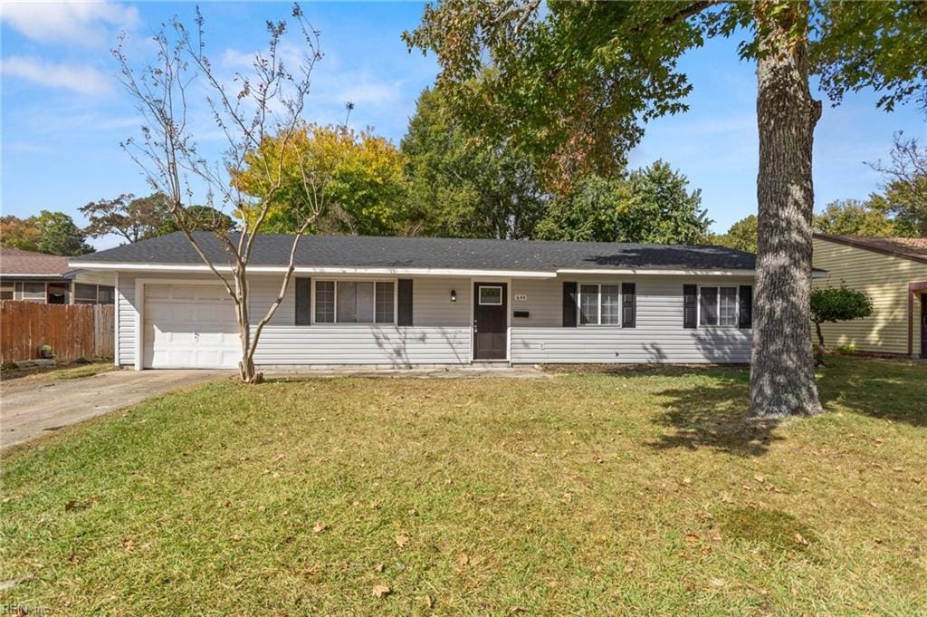 ranch-style house with a front yard and a garage