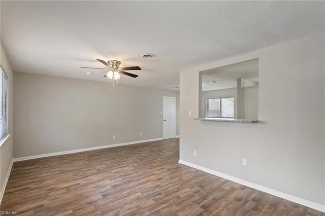 unfurnished room featuring ceiling fan and dark hardwood / wood-style flooring