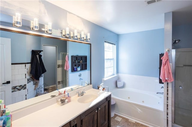 bathroom with vanity and independent shower and bath