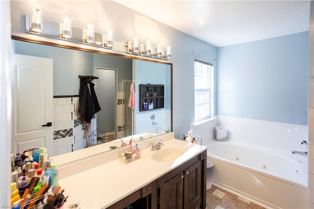 bathroom featuring a bathtub, vanity, and tile patterned flooring