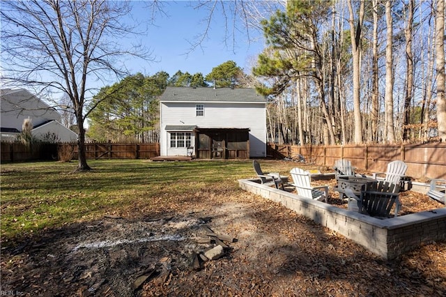 rear view of property featuring an outbuilding and a yard