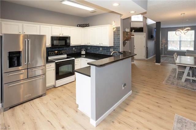 kitchen featuring white range with electric cooktop, white cabinets, decorative light fixtures, high end fridge, and kitchen peninsula