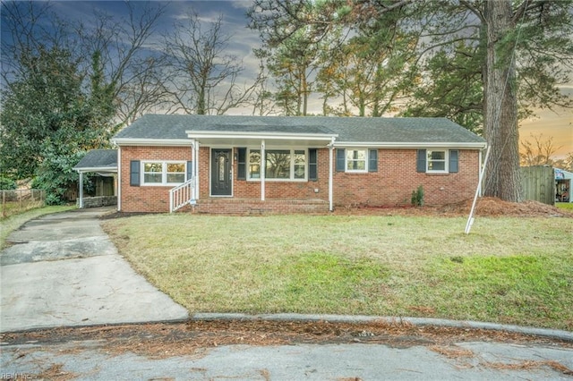 view of front of house with a carport and a yard