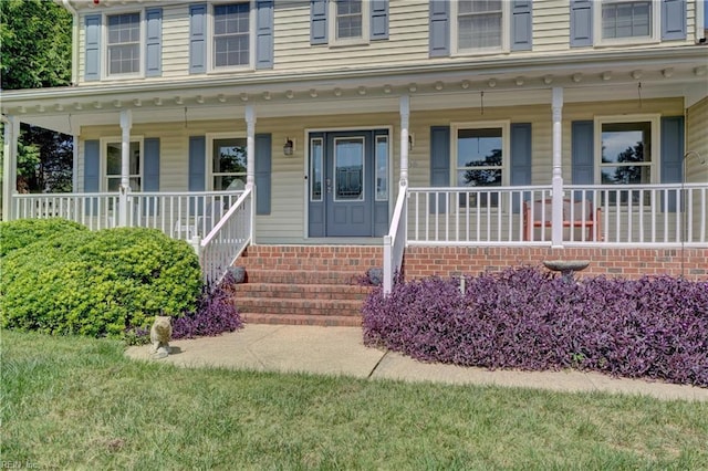 view of exterior entry with a porch