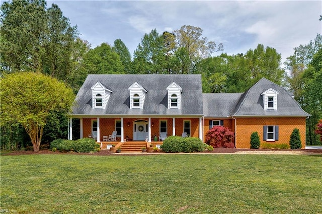 cape cod home featuring covered porch and a front yard