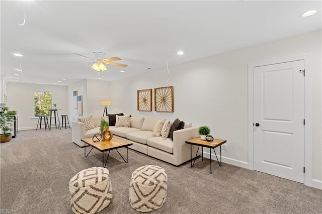 living room featuring ceiling fan and light colored carpet