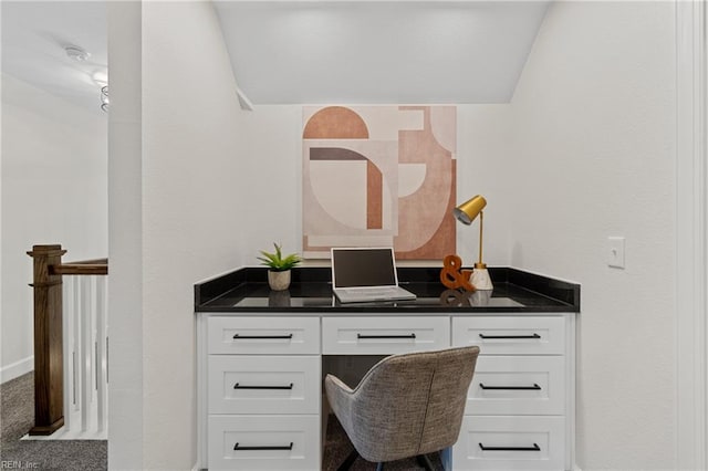 carpeted office featuring vaulted ceiling