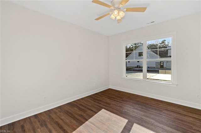 spare room featuring dark hardwood / wood-style flooring and ceiling fan