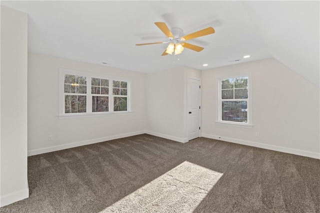 bonus room with dark colored carpet, ceiling fan, and vaulted ceiling