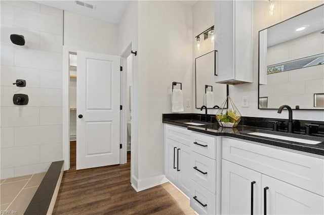 bathroom with hardwood / wood-style floors and vanity