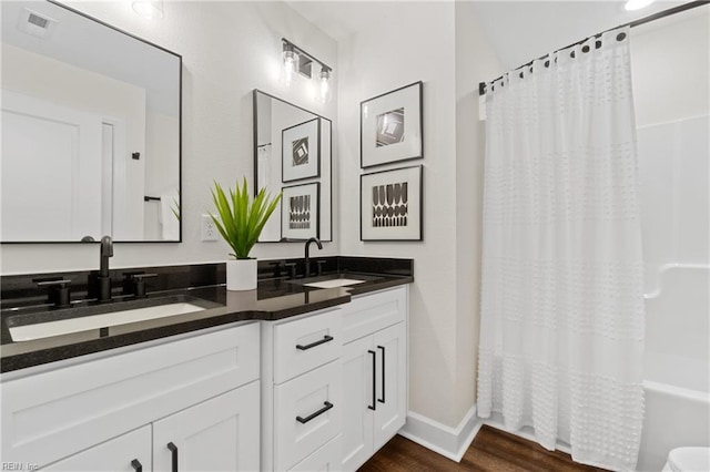 bathroom featuring vanity, wood-type flooring, and shower / tub combo with curtain