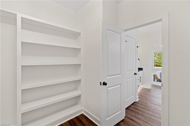 corridor with dark hardwood / wood-style floors