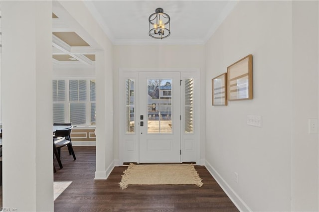 entryway featuring ornamental molding, dark wood-type flooring, and a chandelier