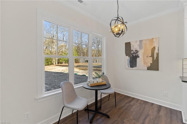 interior space with a chandelier, dark hardwood / wood-style floors, and ornamental molding