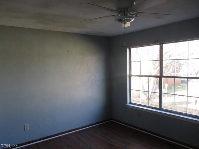 empty room featuring dark hardwood / wood-style floors and ceiling fan