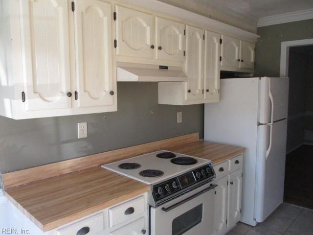 kitchen featuring tile patterned flooring, white appliances, white cabinetry, and crown molding