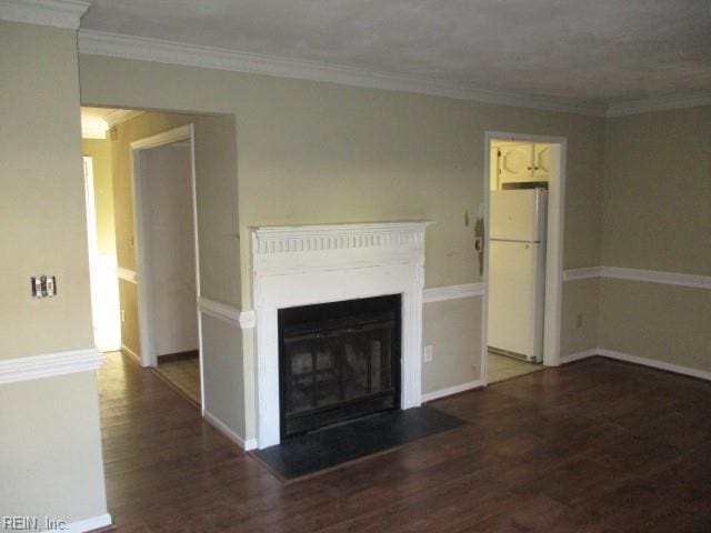 unfurnished living room featuring dark hardwood / wood-style floors and crown molding