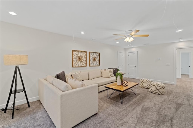 carpeted living room with ceiling fan