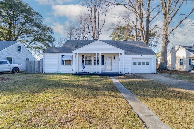 view of front of home with a porch, a garage, and a front yard