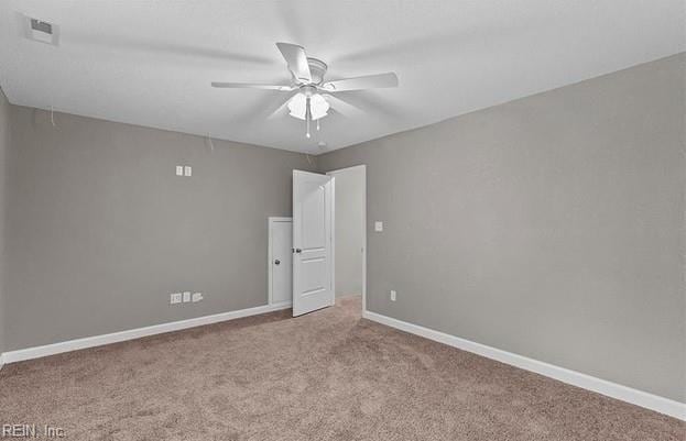 empty room featuring light colored carpet and ceiling fan