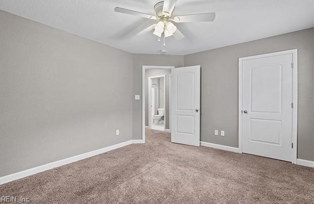 unfurnished bedroom with ceiling fan and carpet floors