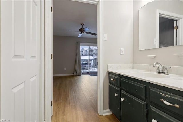 bathroom featuring ceiling fan, hardwood / wood-style floors, and vanity