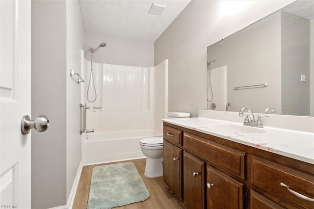 full bathroom with hardwood / wood-style flooring, vanity, toilet, and shower / washtub combination