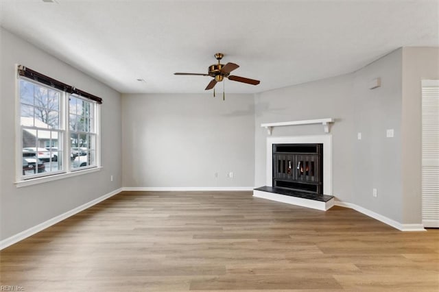 unfurnished living room with light hardwood / wood-style floors and ceiling fan