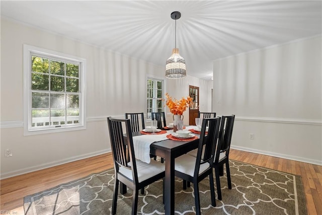 dining area featuring hardwood / wood-style flooring and a notable chandelier