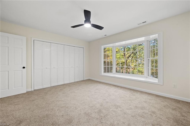 unfurnished bedroom featuring ceiling fan and carpet