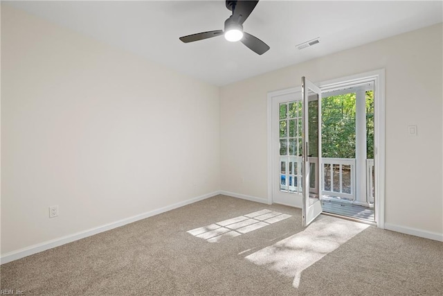 carpeted spare room with ceiling fan